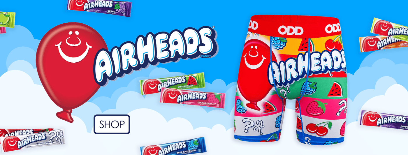 Airheads candy-inspired boxer briefs with vibrant fruit patterns, surrounded by Airheads candy wrappers and a smiling red balloon logo on a cloud background.